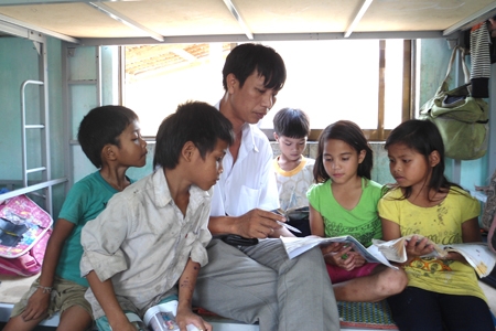 Thầy giáo Đặng Văn Cương  với các học trò thôn Gò Da trong giờ phụ đạo tại phòng nội trú.