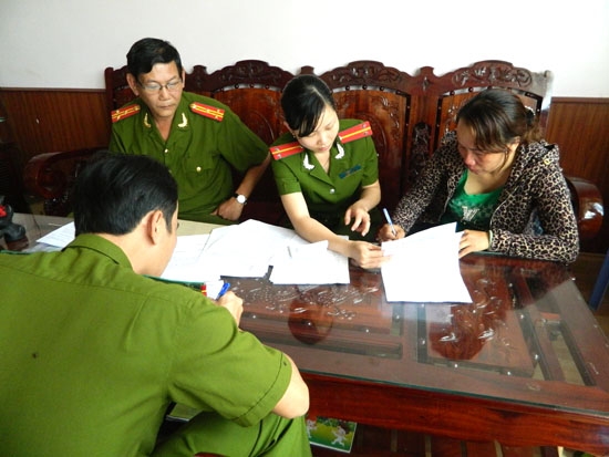 Cơ quan CSĐT làm thủ tục bắt tạm giam bà Nguyễn Thị Xuân (bên phải).