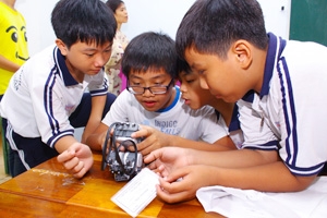 Các học sinh tiểu học say mê lắp ráp robot. Ảnh VGP/Thanh Thủy 