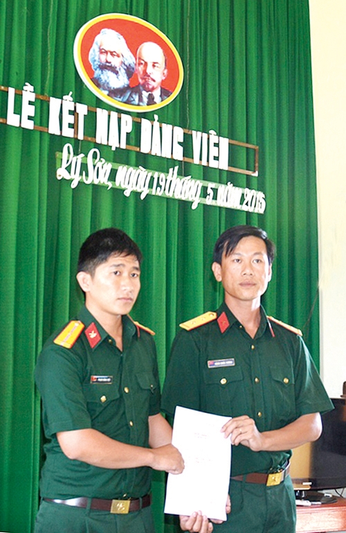 Đảng viên trẻ, thiếu úy Phạm Hoàng Việt (bên trái) nhận quyết định kết nạp Đảng.