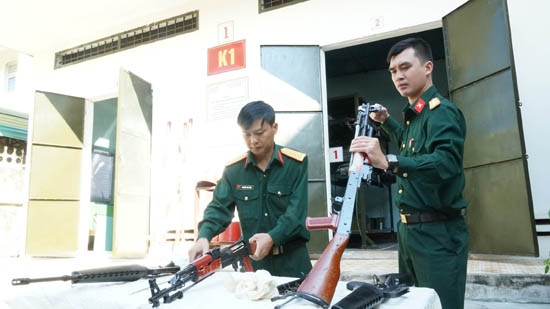 Đại úy Nguyễn Văn Tiến (trái) và cộng sự với ứng dụng tiểu liên AK Laser bắn mục tiêu bia phản quang trên biển ban đêm.