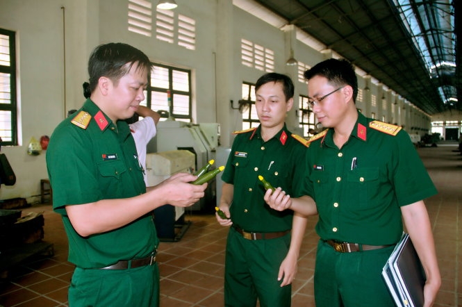 Đại úy Mai Thanh Uyên ( trái) trao đổi công việc cùng hai đồng nghiệp - Ảnh: MẠNH CHIẾN