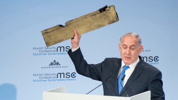 Thủ tướng Benjamin Netanyahu giơ mảnh vỡ máy bay do thám tại Hội nghị an ninh Munich ngày 18/2 (Ảnh: AP)