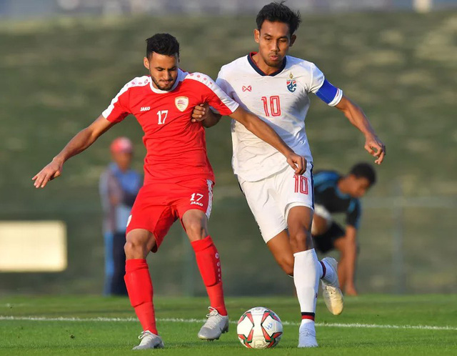 Đội trưởng ĐT Thái Lan Dangda (áo trắng) trong pha tranh chấp bóng với cầu thủ Oman