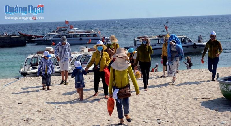 Bất chấp thời tiết nắng nóng, du khách vẫn háo hức đi tham quan đảo Bé, họ trùm kín mặt để bảo vệ sức khỏe.
