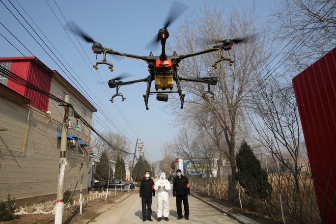 Tình nguyện viên điều kiển thiết bị bay không người lái phun thuốc khử trùng tại làng Zhengwan, tỉnh Hà Bắc – Trung Quốc. Ảnh: Reuters