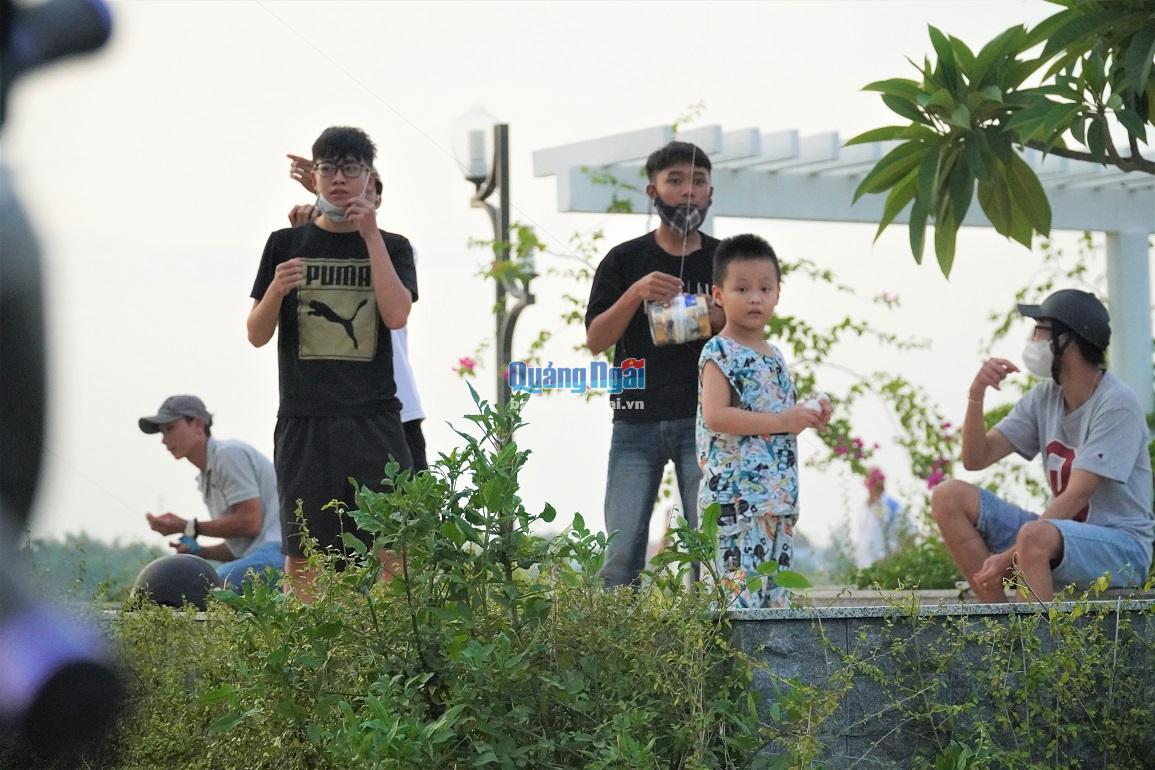 Một nhóm thanh niên tụ tập hóng mát, thả diều ngay công viên gần cầu Thạch Bích,  đường Tôn Đức Thắng (TP.Quảng Ngãi).