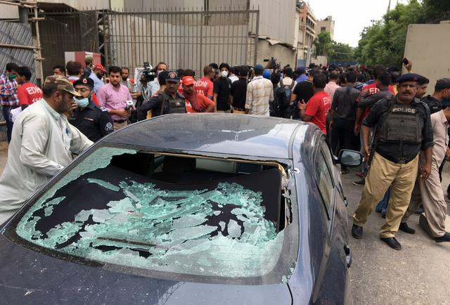 Một sĩ quan cảnh sát Pakistan điều tra hiện trường vụ xả súng hôm 29/6 tại trụ sở Sàn giao dịch chứng khoán ở Karachi (Ảnh: Reuters)