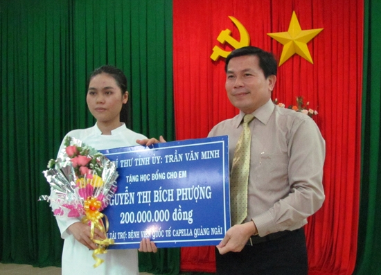 Phó Bí thư Tỉnh ủy Trần Văn Minh trao học bổng cho Bích Phượng.