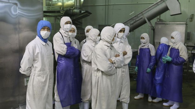 Các nhân viên cơ quan quản lý thuốc và thực phẩm đang làm nhiệm vụ tại một công ty thực phẩm ở Thượng Hải, Trung Quốc hôm 20-7 - Ảnh: Reuters