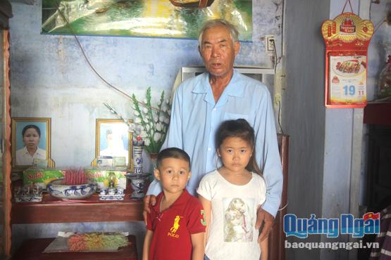Ông Nguyễn Văn Hiếu và hai cháu Ngọc, Trung bên bàn thờ cha mẹ.