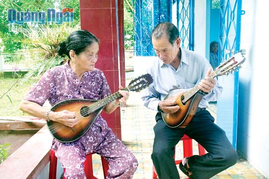 Bà Hồ Thị Ấm hòa tấu Mandolin cùng thành viên trong ban nhạc người cao tuổi.