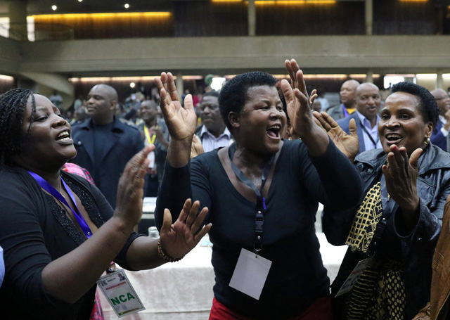  Các thành viên trong đảng ZANU-PF ăn mừng sau khi ông Mugabe bị phế truất chức chủ tịch đảng - Ảnh: REUTERS