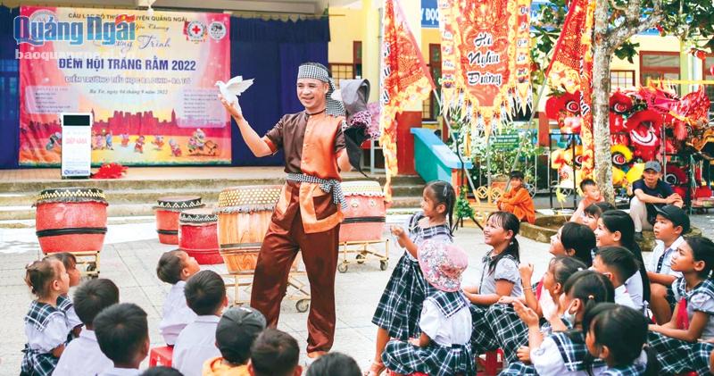 Các em học sinh Trường Tiểu học Ba Dinh (Ba Tơ) xem biểu diễn ảo thuật trong đêm hội trăng rằm do CLB Thiện nguyện Quảng Ngãi tổ chức.  Ảnh: Duy Nhật