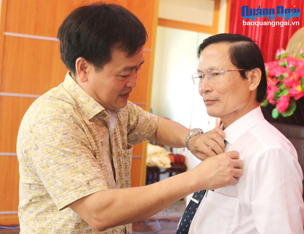 Phó Chủ tịch Thường trực HĐND tỉnh Nguyễn Cao Phúc gắn Huy hiệu 30 năm tuổi Đảng cho Phó Bí thư Thường trực Huyện ủy Bình Sơn Đỗ Thiết Khiêm.