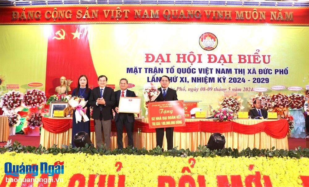 Trao Bằng khen của Ủy ban MTTQ Việt Nam tỉnh cho Ủy ban MTTQ Việt Nam thị xã Đức Phổ và bảng tượng trưng hỗ trợ xây dựng nhà đại đoàn kết. (Ảnh: Nhật Sơn)