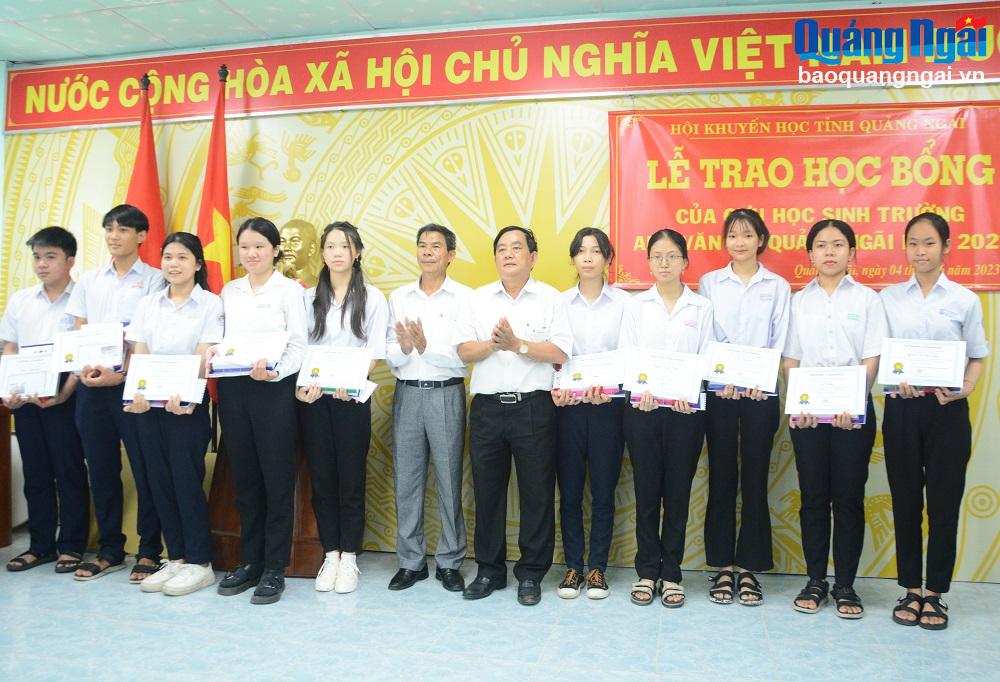 Phó Chủ tịch Thường trực Hội Khuyến học tỉnh Trần Tấn Châu và Phó Giám đốc Sở GD&ĐT Nguyễn Văn Tâm trao học bổng cho học sinh. 