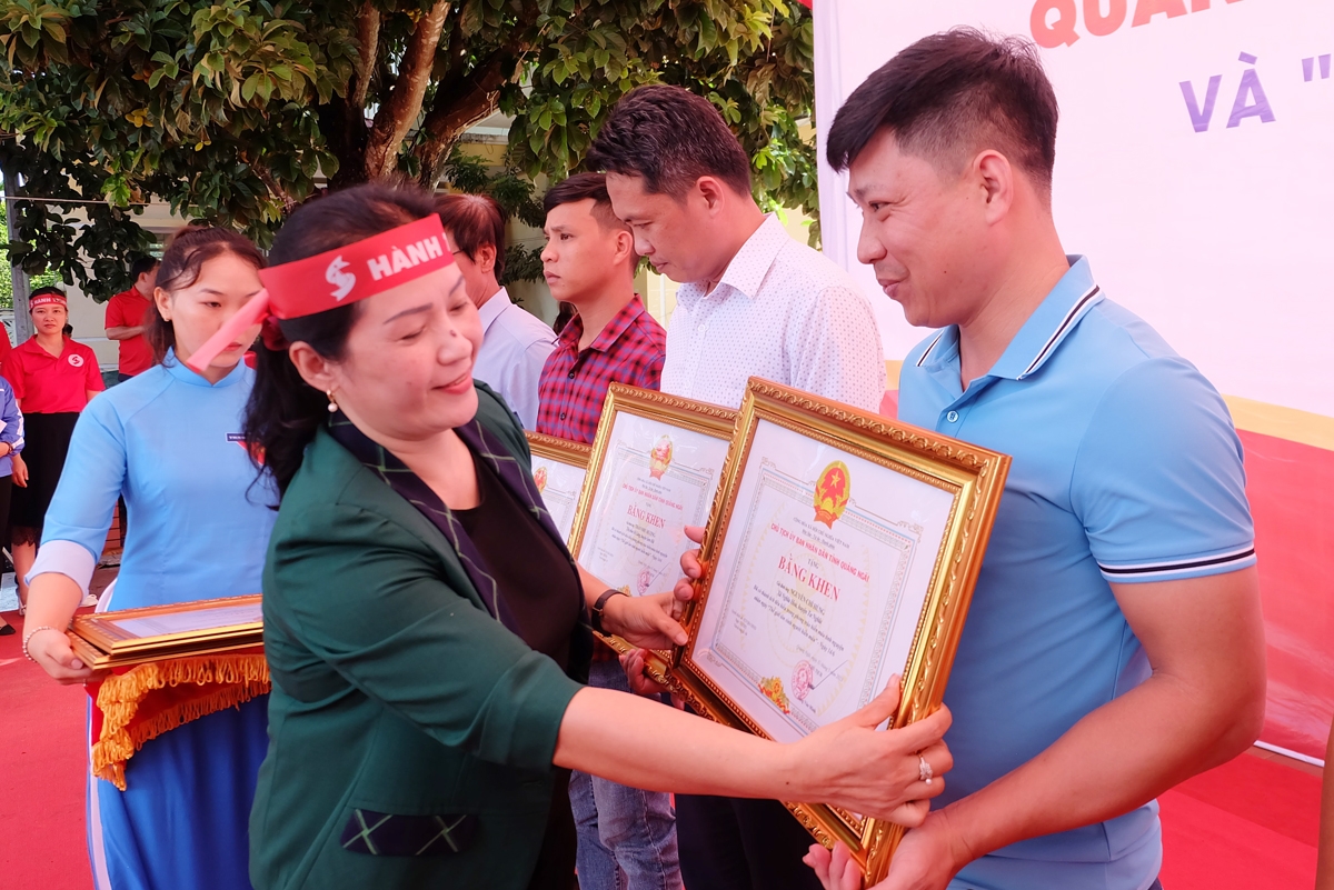 Phó Bí thư Tỉnh ủy Đinh Thị Hồng Minh trao Bằng khen của Chủ tịch UBND tỉnh cho các gia đình có thành tích tiêu biểu trong phong trào hiến máu tình nguyện.     