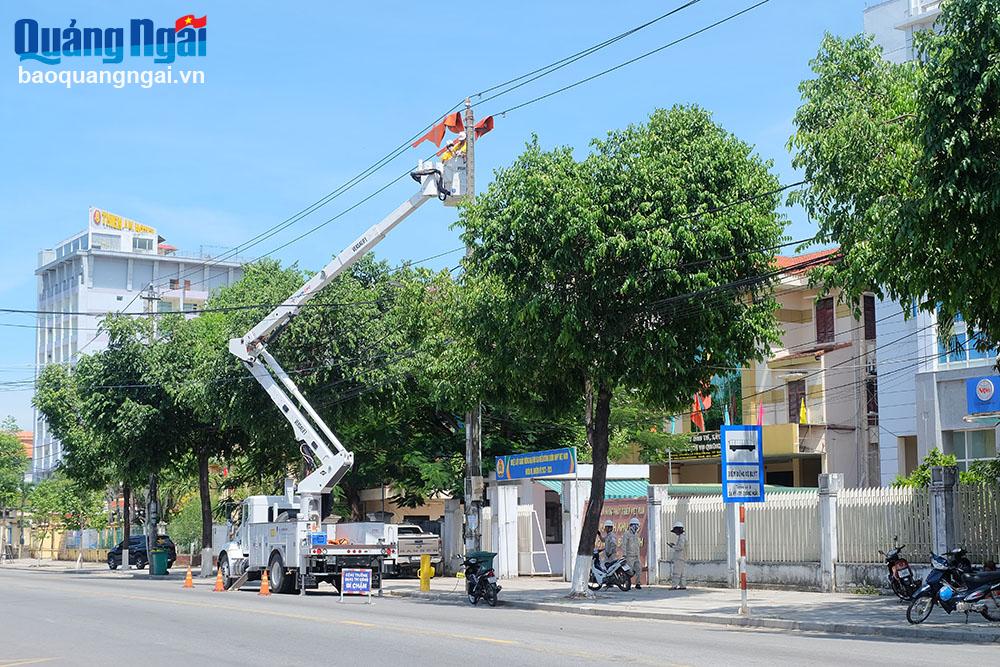 Công nhân Công ty Điện lực Quảng Ngãi thực hiện sửa chữa điện nóng Hotline trên đường Hai Bà Trưng (TP.Quảng Ngãi).