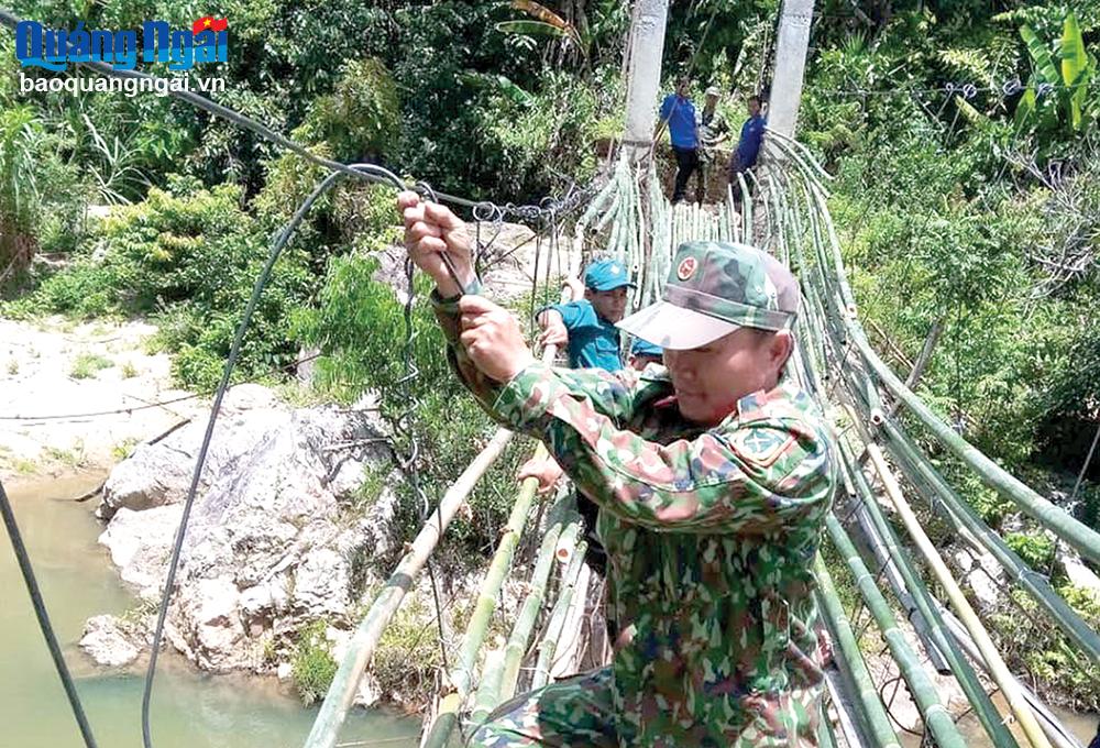 Bộ đội làm cầu treo giúp người dân thôn Mang He, xã Sơn Bua đi lại được thuận lợi.
