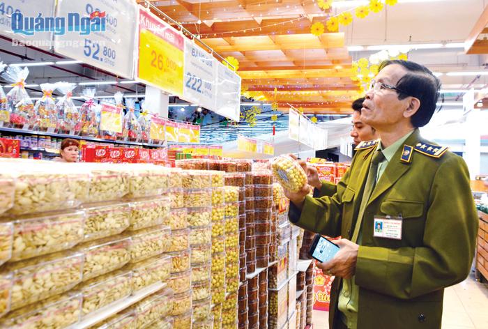 Cán bộ Cục Quản lý thị trường tỉnh kiểm tra hàng hóa được bày bán tại một siêu thị trên địa bàn TP.Quảng Ngãi.