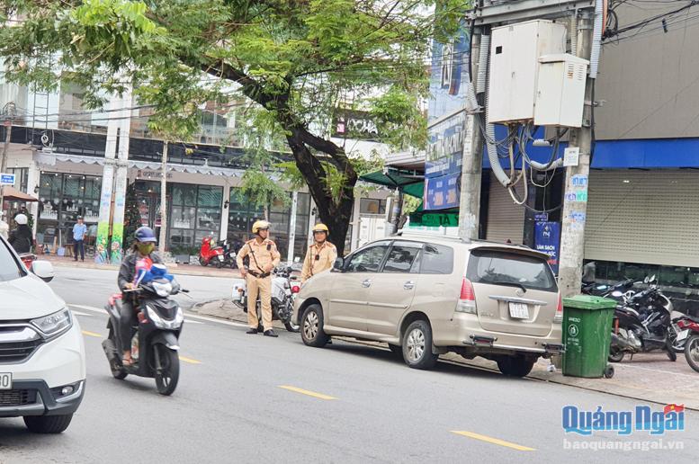 Lực lượng cảnh sát giao thông xử lý phương tiện đậu đỗ sai quy định trên đường Phan Đình Phùng (TP.Quảng Ngãi).