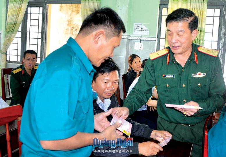 Phó Chính ủy Quân khu 5, Thiếu tướng Trương Thiên Tô tặng quà người dân huyện Sơn Tịnh.                Ảnh: T.DUY