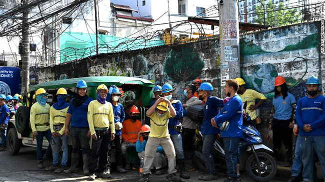 Công nhân xây dựng sơ tán khỏi một tòa nhà sau trận động đất mạnh 7,1 độ ở Manila, ngày 27/7. (Ảnh: CNN)